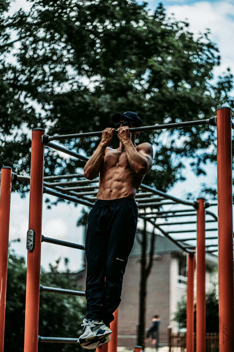 Muscular Man Training on Bar Outdoors